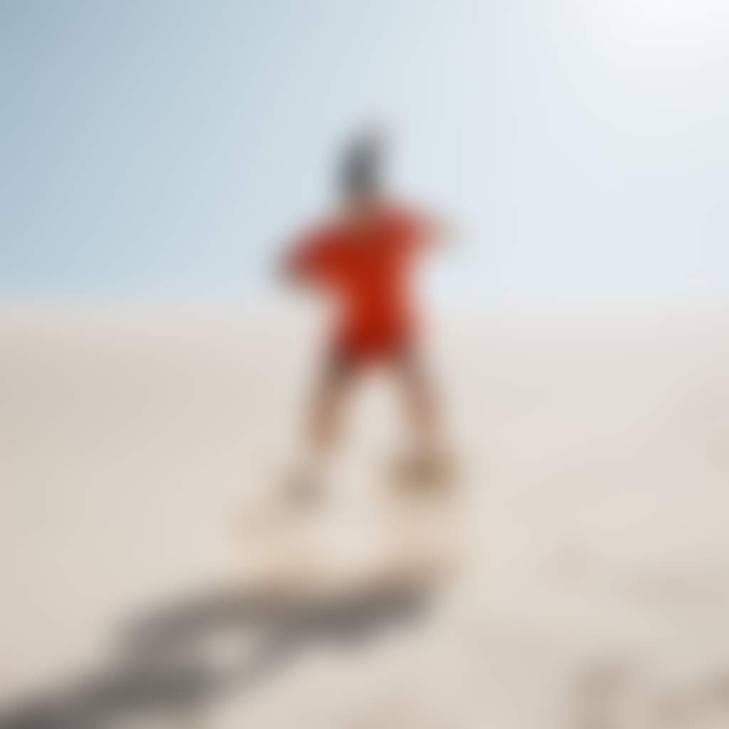 Woman sandboarding on sand dunes in port stephens