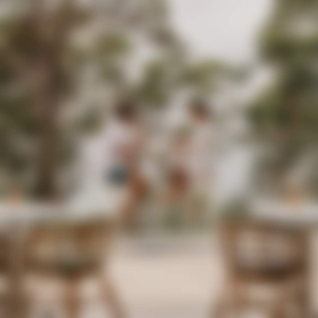 Couple enjoying wine at an outdoor bar table overlooking the water in Port Stephens