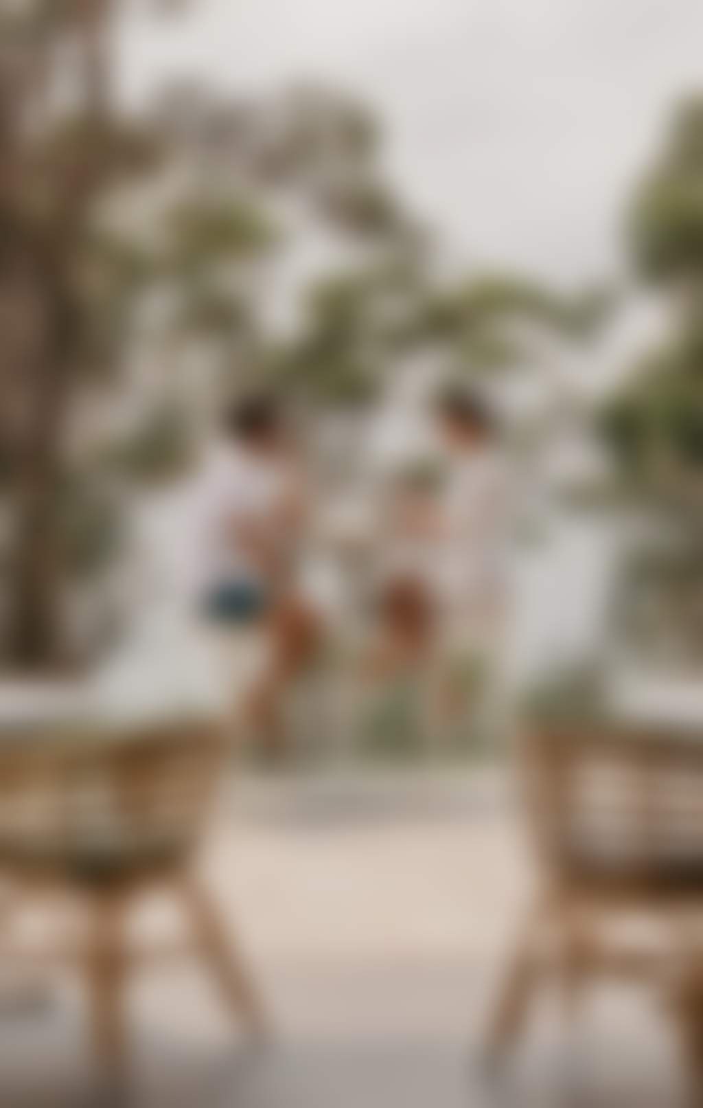 Couple enjoying wine at an outdoor bar table overlooking the water in Port Stephens